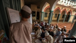 FILE - Pakistani religious students attend a lesson at Darul Uloom Haqqania, an Islamic seminary and alma mater of several Taliban leaders, in Akora Khattak, Khyber Pakhtunkhwa province.
