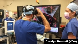 Stanford Director of Neurosurgery Dr. Gary Steinberg joins Malie Collins for a final refresher of the location of the aneurysm before Steinberg begins the surgery. Collins is the program manager of the Stanford Neurological Simulation & Virtual Reality Center.