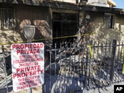 Police tape marks off the burned front lobby of the Islamic Center of Palm Springs in Coachella, Calif., Dec. 12, 2015.