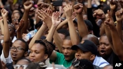Students sits on the street during their protest against university tuition hikes outside the ruling party African National Congress (ANC) headquarters in Johannesburg, South Africa, October 22, 2015.