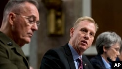 Acting Defense Secretary Patrick Shanahan, center, accompanied by Joint Chiefs Chairman Gen. Joseph Dunford, left, and Secretary of the Air Force Heather Wilson, speaks during a Senate Armed Services Committee hearing on Capitol Hill in Washington, April 11, 2019, on the proposed U.S. Space Force.