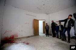 Palestinians look at a damage after an Israeli raid killed Ashraf Naalweh during an arrest raid in the Asker refugee camp near the West Bank city of Nablus, Thursday, Dec. 13, 2018.