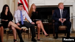 Marjory Stoneman Douglas High School shooting surviving students Jonathan Blank, 2nd from left, and Julia Cordover, as well as Jonathan's mother Melissa Blank, left, listen along with President Donald Trump during a listening session at the White House.