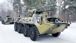 In this photo taken from video released by the Russian Defense Ministry Press Service, military vehicles of Russian peacekeepers are waiting to be transported to Russian military planes at an airfield outside Moscow, before being flown to Kazakhstan Jan. 6, 2022.