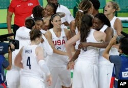 U.S. players celebrate after the gold medal basketball game against Spain at the 2016 Summer Olympics in Rio de Janeiro, Brazil, Aug. 20, 2016.