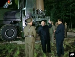 FILE - In this image made from video by North Korea's KRT, July 28, 2017, North Korean leader Kim Jong Un gestures at the site of a missile test at an undisclosed location in North Korea.