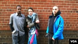 Joseph, Felix and Jeffrey (l to r) have been staying in a temporary shelter since Monday night, when Hurricane Sandy struck. (VOA photo - A. Phillips)