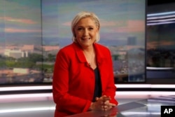 Former French presidential election candidate for the far-right Front National party Marine Le Pen poses prior to an interview on the evening news broadcast of French TV channel TF1, May 18, 2017, in Boulogne-Billancourt, near Paris.