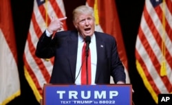 Republican Presidential candidate Donald Trump comments about his hair while speaking at a rally in Raleigh, N.C., Tuesday, July 5, 2016.