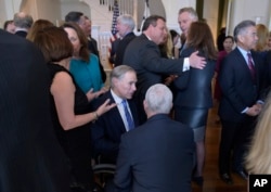 Texas Gov. Greg Abbott, center, talks with Vice President Mike Pence during a luncheon for governors at the Naval Observatory in Washington, Feb. 24, 2017.