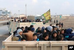 Iraqi people flee the Islamic State stronghold in the town of Bartella, east of Mosul, Dec. 28, 2016.