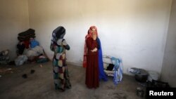 Civilians are seen inside their home in Raqqa's western neighborhood of Jazra, Syria, June 11, 2017.