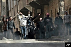 FILE - Anti-Syrian government demonstrators take to the streets in the southern city of Daraa, March 23, 2011.
