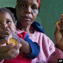 HIV positive child is given some jam prior to her ARV, near Durban, South Africa, 30 Nov 2010