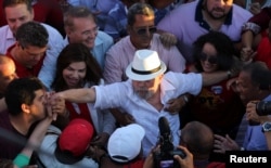 Former Brazilian President Luiz Inacio Lula da Silva, center, attends a rally in the northeastern city of Penedo in Alagoas, Brazil, Aug. 22, 2017.