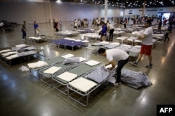 Volunteers set up additional cots for Hurricane Harvey evacuees at the NRG Center in Houston, Texas, Aug. 31, 2017.