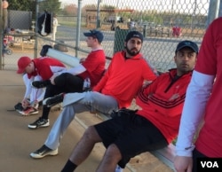 Danish Bashir, center, sits in the dugout at a softball game in Springfield, Virginia. (C. Presutti/VOA)