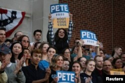 FILE - Attendees cheer as 2020 Democratic presidential candidate Pete Buttigieg speaks at a campaign event in Des Moines, Iowa, April 16, 2019.