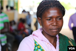 Cecilia Arnaldo waits to be screened and have pre-cancerous cells removed. "I am not ashamed," she says. Boane, Mozambique, Nov. 20, 2014. (Gillian Parker/VOA)