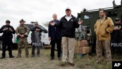 President Donald Trump speaks as tours the U.S. border with Mexico at the Rio Grande on the southern border, Thursday, Jan. 10, 2019, in McAllen, Texas, as Sen. John Cornyn, R-Texas, left, and Sen. Ted Cruz, R-Texas, listen.