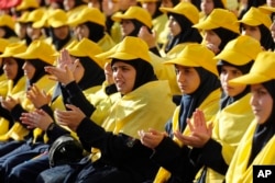 Hezbollah supporters applaud as they listen to Hezbollah leader Sayyed Hassan Nasrallah on a televised speech on giant screens during an election campaign in a southern suburb of Beirut, Lebanon, April 13, 2018. Nasrallah said a recent attack on an air base ushered in a new phase that puts Israel in a state of "direct confrontation" with Iran.