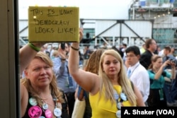 &quot;This is what democracy looks like,&quot; reads a protest sign held by a Bernie Sanders supporter after Hillary Clinton was formally nominated at the Democratic National Convention in Philadelphia, July 26, 2016 (A. Shaker/VOA)