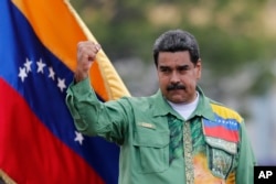 Venezuela's President Nicolas Maduro raises his fist during a closing campaign rally in Caracas, May 17, 2018.