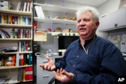 FILE - Amr Al Azm, a professor of Middle East History and Anthropology at Shawnee State University, speaks at his office in Portsmouth, Ohio, April 25, 2019.