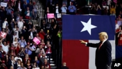 President Donald Trump points into the crowd during a campaign rally for Sen. Ted Cruz, R-Texas, at Houston Toyota Center, Oct. 22, 2018, in Houston.