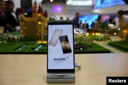 FILE - A ZTE Axon7 device is displayed at company's booth during Mobile World Congress in Barcelona, Spain, Feb. 27, 2017.