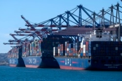 Cargo containers sit stacked on ships at the Port of Los Angeles, Oct. 20, 2021 in San Pedro, California. Gov. Gavin Newsom on Wednesday issued an order that aims to ease bottlenecks at the ports of Los Angeles and Long Beach that have spilled over into neighborhoods.