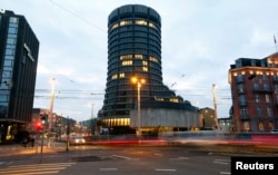 FILE - Traffic flows in front of the Bank for International Settlements (BIS) in Basel, Switzerland.