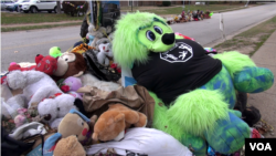 Mementos mark the site where Michael Brown was killed by a local police officer, Ferguson, Missouri, Nov. 13, 2014. (Ayesha Tanzeem/VOA)
