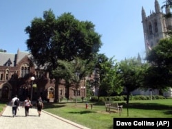 People walk on campus at Trinity College, a private college in Hartford, Connecticut.
