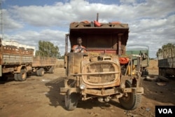 Ali Hassan Abdi drives a truck between Mogadishu and Baidoa. He keeps his truck in a state of disrepair to avoid heavier taxes at al- Shabaab checkpoints, August 24, 2012.