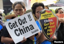 Protesters make noise during a rally regarding the disputed islands in the South China Sea, in front of the Chinese Consulate in Makati city, metro Manila July 24, 2015.
