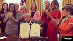 President Donald Trump at the White House, signing two laws that authorize NASA and the National Science Foundation to encourage women and girls to get into STEM fields.