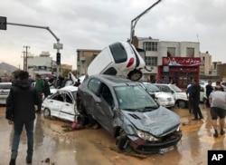 Vehicles are piled up on a street after a flash flood in the southern city of Shiraz, Iran, March 25, 2019.