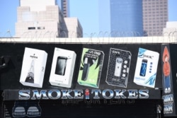 In this file photo taken on September 17, 2019 A sign advertises Juul vaping products in Los Angeles, California, September 17, 2019.