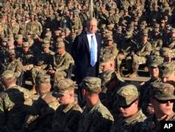 FILE - Then-Defense Secretary Jim Mattis talks to U.S. troops at Guantanamo Bay, Cuba, Dec. 21, 2017.