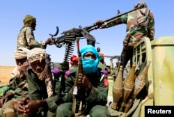 FILE - Military personnel patrol in Tabit village in North Darfur, Nov. 20, 2014, as region's joint peacekeeping mission, UNAMID, continues to seek access to Tabit since earlier this month to investigate media reports of an alleged mass rape of women and