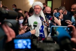 Taliban official Abdul Salam Hanafi, center, speaks to media during an international Russia-hosted meeting on Afghanistan, in Moscow, Russia, Oct. 20, 2021.