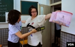 A student goes through a security check as she enters the classroom to take the National College Entrance Exam in Shenyang, Liaoning province in 2013. (REUTERS)