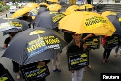 Activists in support of the pro-democracy demonstrations in Hong Kong protest in front of the Chinese Consular office in Makati city, metro Manila, Oct. 2, 2014.