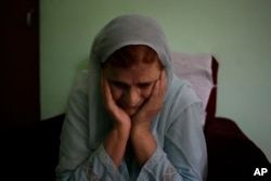 Shamsul Nisa, 80, breaks down as she narrates her story to the Associated Press inside her house in Srinagar, Indian controlled Kashmir, Aug. 5, 2017. Nisa was 10 when she watched her Muslim father, grandfather and six uncles killed by Hindu mobs.