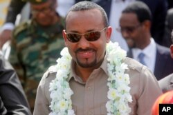 FILE - The new prime minister of Ethiopia, Abiy Ahmed, visits Mogadishu, Somalia, June 16, 2018.