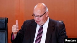 FILE - German Chancellery minister Peter Altmaier attends the weekly cabinet meeting at the Chancellery in Berlin, Germany, Sept. 27, 2017.