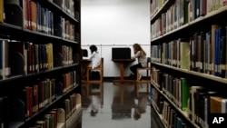 FILE - Students are seen studying in a library on the campus of California State University in Long Beach, California, Oct. 19, 2012. Advocates of the "gap year" say it helps young people gain experiences they cannot learn from books.