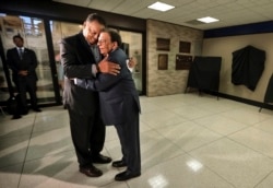 This Monday, April 3, 2017 file photo shows civil rights activist Jesse Jackson and former UN Ambassador Andrew Young embracing during a ceremony at the Memphis International Airport to unveil a historic marker commemorating the final flight of Dr. King.