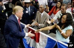 Republican presidential hopeful Donald Trump shakes hands with supporters after speaking at a campaign event in Dallas, Texas, Sept. 14, 2015.
